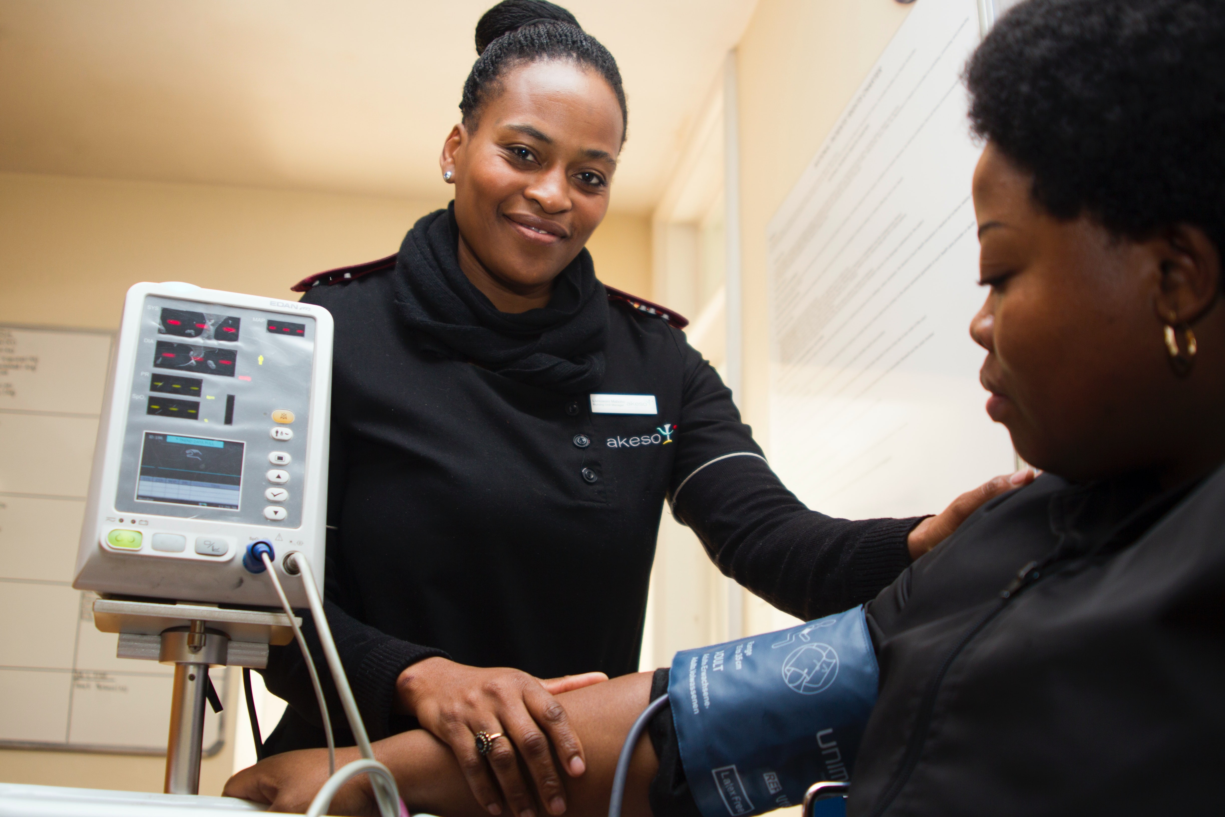 Image of a medical professional taking the blood pressure of a patient